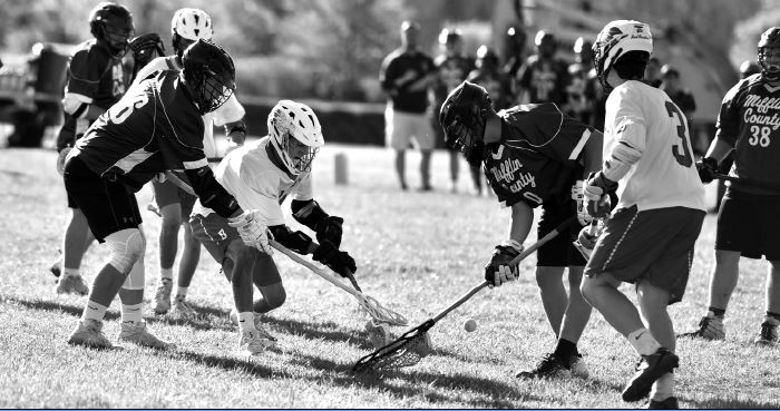 Members of the boys’ lacrosse team fight for a ground ball against Mifflin County. 