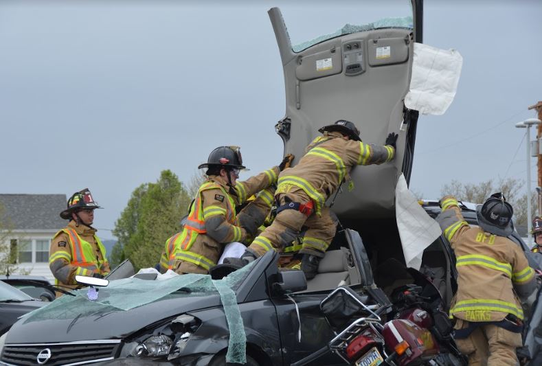 Members of the Logan Fire department disassemble a wrecked vehicle to demonstrate the intense process of extracting victims from a car crash. 