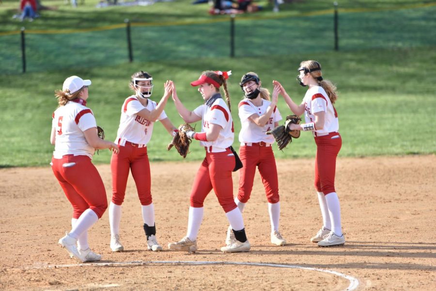 The softball team players on the field during a spring game. 