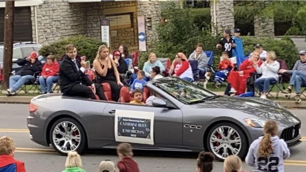 Seniors Catherine Reed and Josh Brown ride in their homecoming car for the parade.