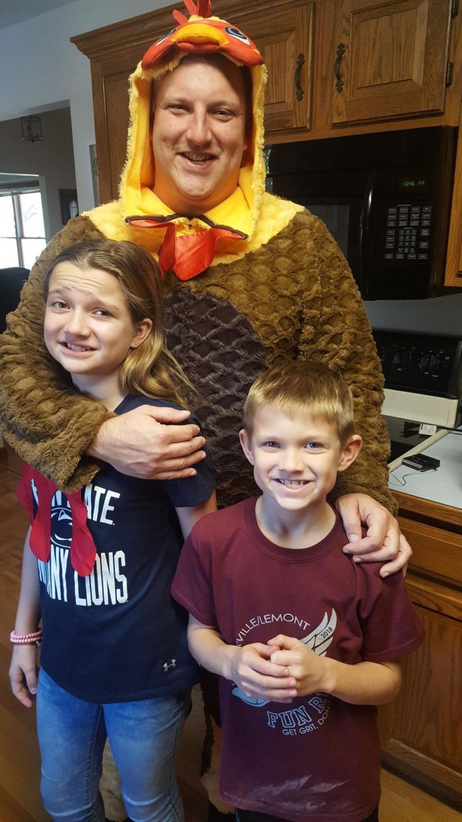 Mr. Myers with his two kids in a turkey costume