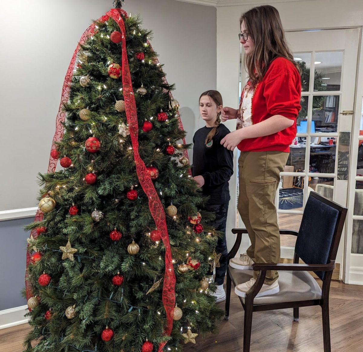 Senior Lily Cramer and freshman Emma Kopcha decorate for Christmas at Celebration Villa of Nittany Valley nursing home.