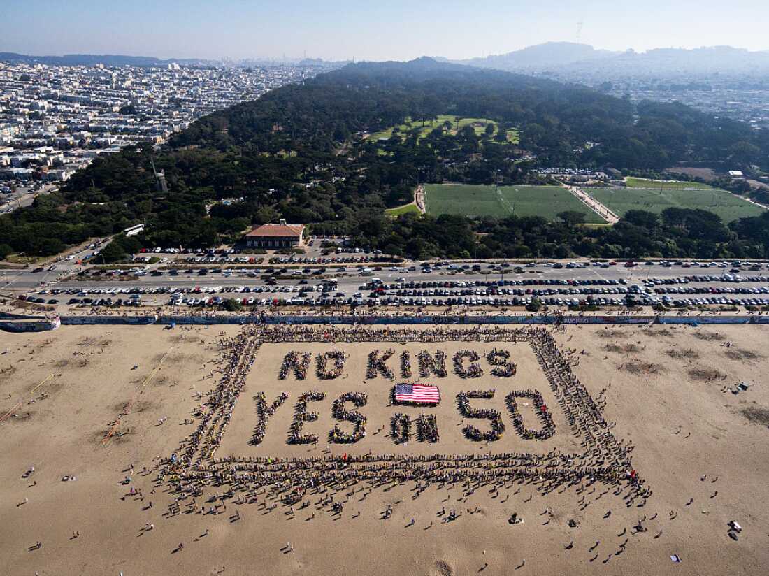 This aerial picture taken on October 18, 2025 shows protesters forming a human banner during the "No Kings" national day of protest on Ocean Beach in San Francisco, California. California's November 4, 2025 special election on Proposition 50, is a measure backed by legislative Democrats and Governor Gavin Newsom that, if approved, would redraw the state's congressional districts.
From New York to San Francisco, millions of Americans are expected to hit the streets to voice their anger over President Donald Trump's policies at nationwide "No Kings" protests. (Photo by Laure Andrillon / AFP) (Photo by LAURE ANDRILLON/AFP via Getty Images)